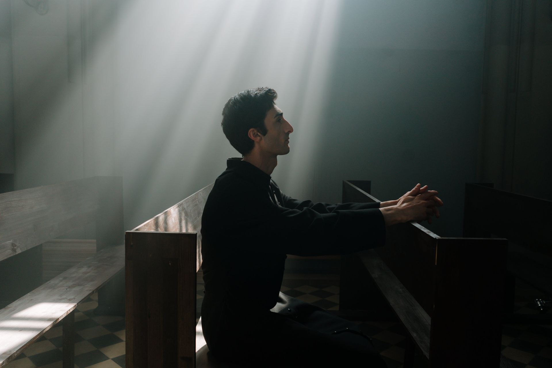 Priest Praying Alone inside a Church